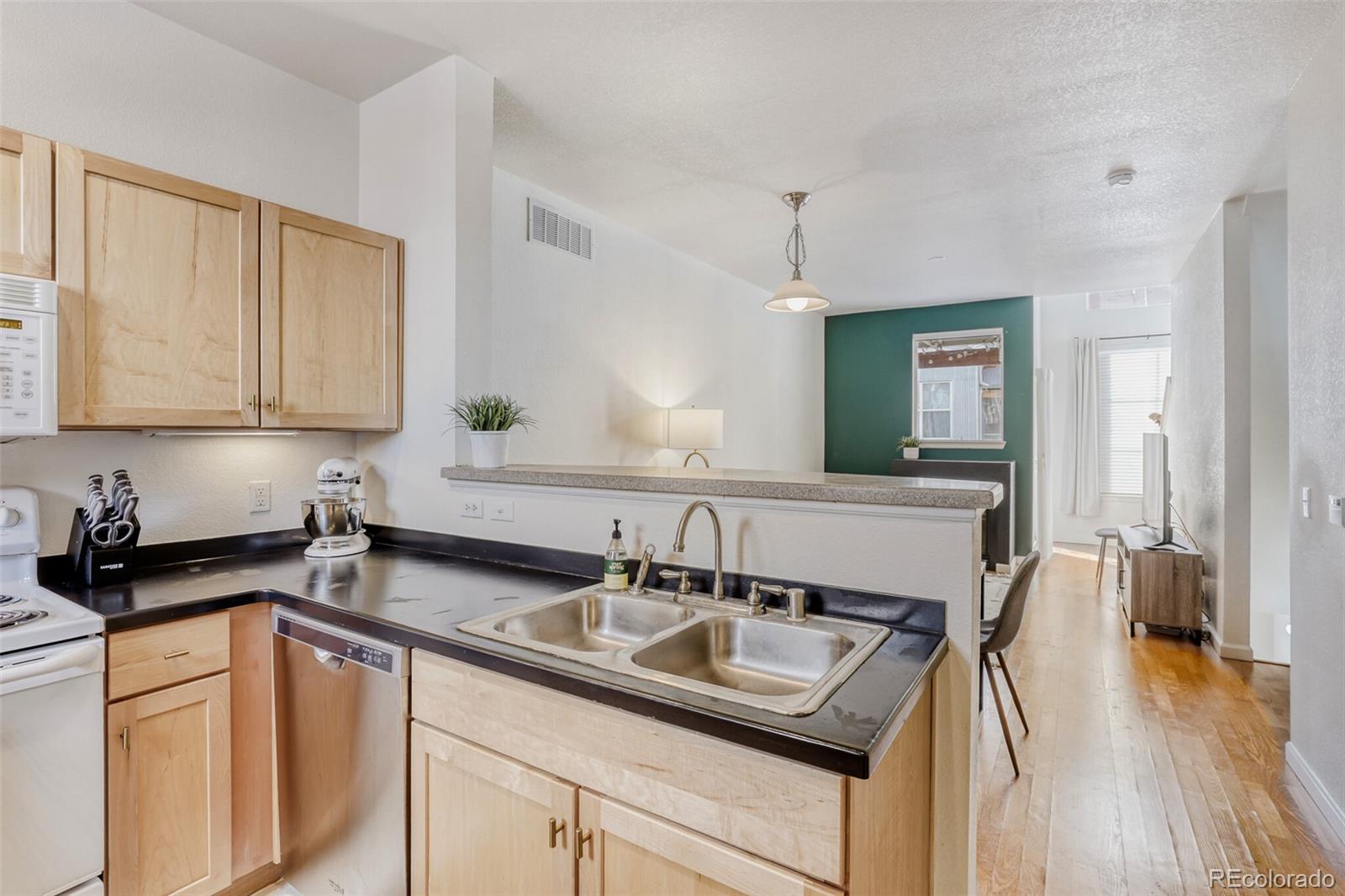 85 Uinta Way, Unit 702 Denver, CO 80230 - Photo 12 of 28 a kitchen with stainless steel appliances granite countertop a sink a stove and cabinets