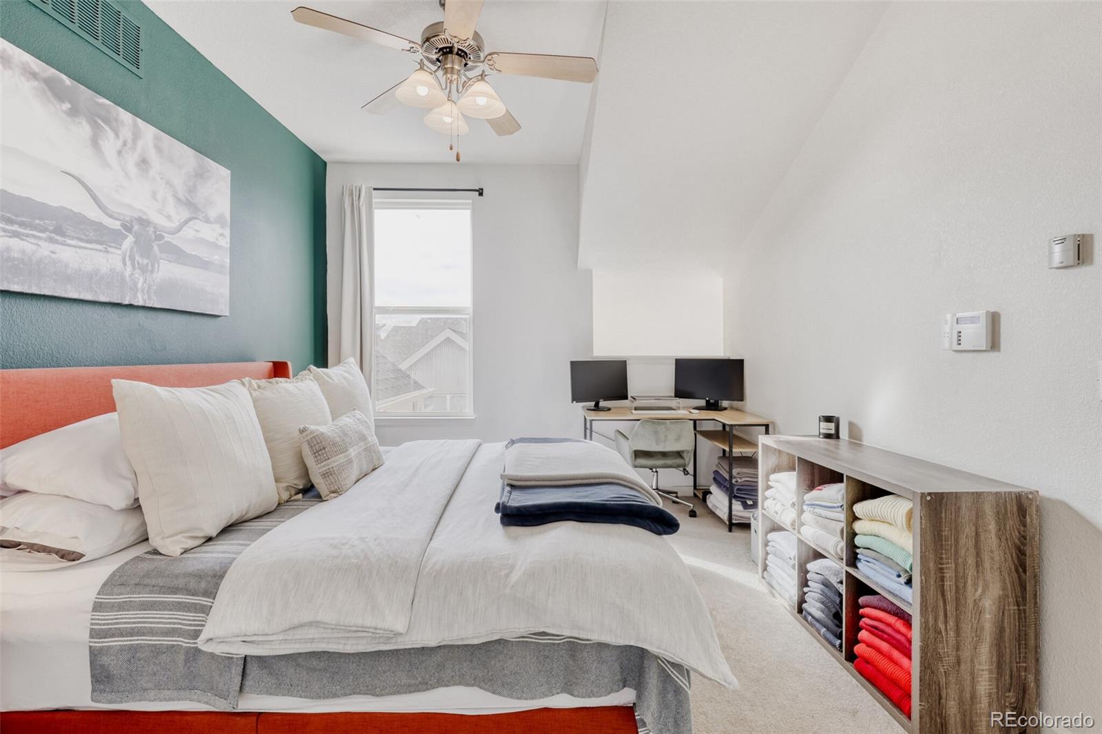 85 Uinta Way, Unit 702 Denver, CO 80230 - Photo 14 of 28 a bedroom with a bed and a chandelier