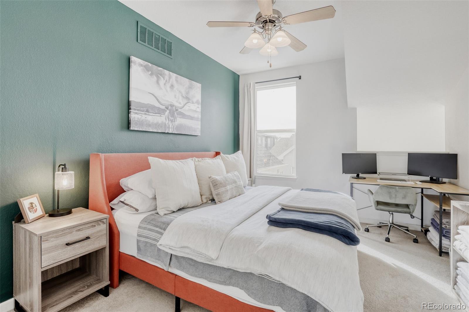 85 Uinta Way, Unit 702 Denver, CO 80230 - Photo 15 of 28 a bedroom with a bed and a chandelier
