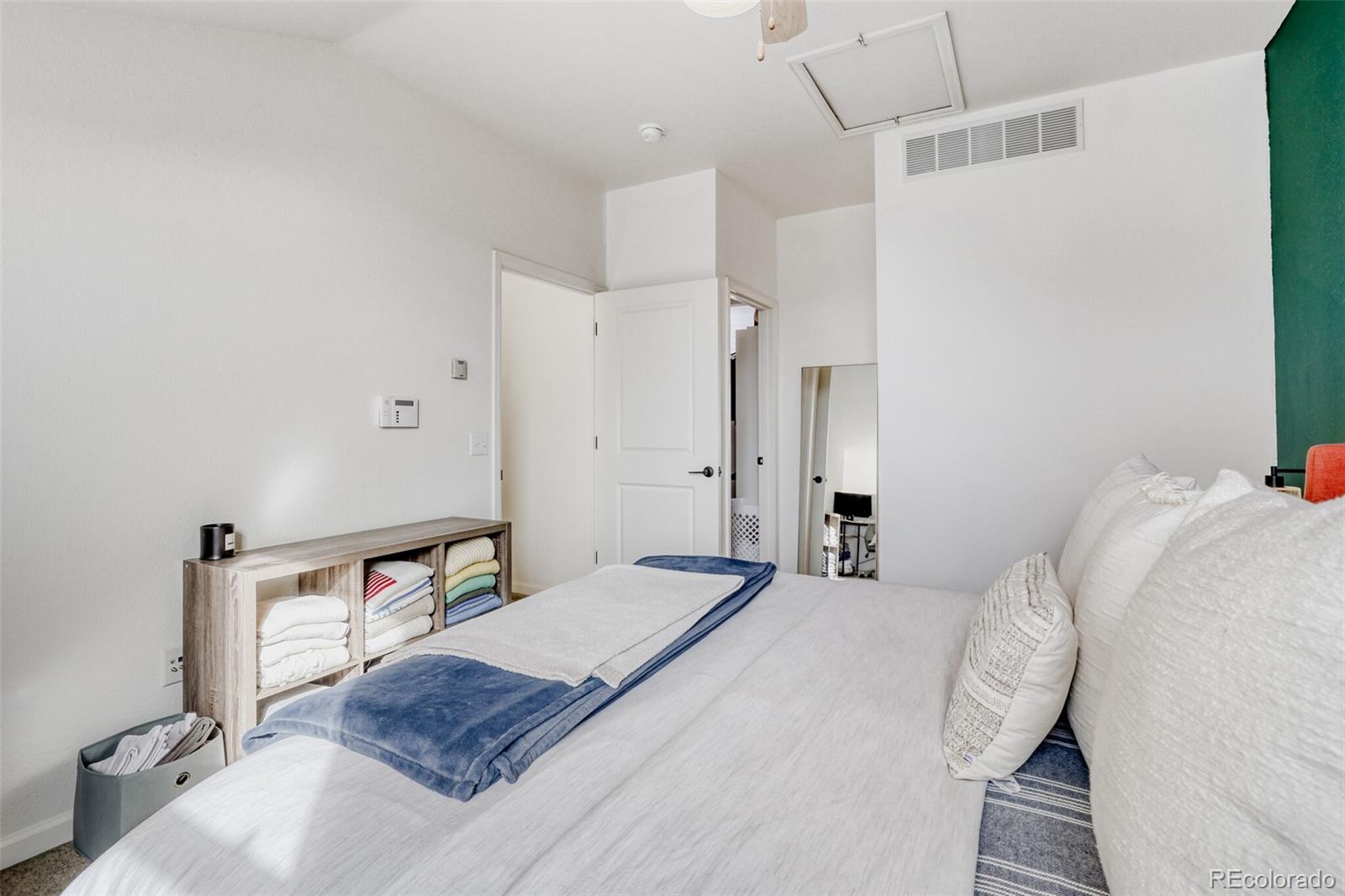 85 Uinta Way, Unit 702 Denver, CO 80230 - Photo 17 of 28 a bedroom with a bed and a table in it