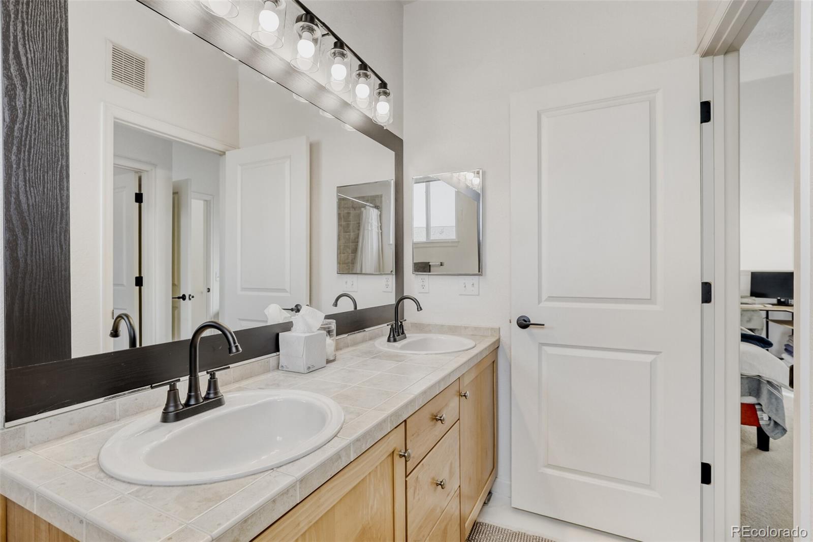 85 Uinta Way, Unit 702 Denver, CO 80230 - Photo 19 of 28 a bathroom with a sink and a mirror