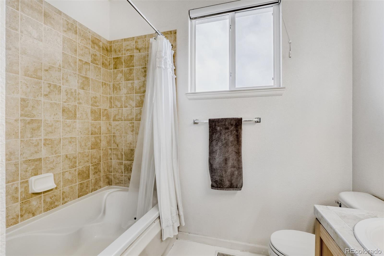85 Uinta Way, Unit 702 Denver, CO 80230 - Photo 20 of 28 a bathroom with a toilet and a shower