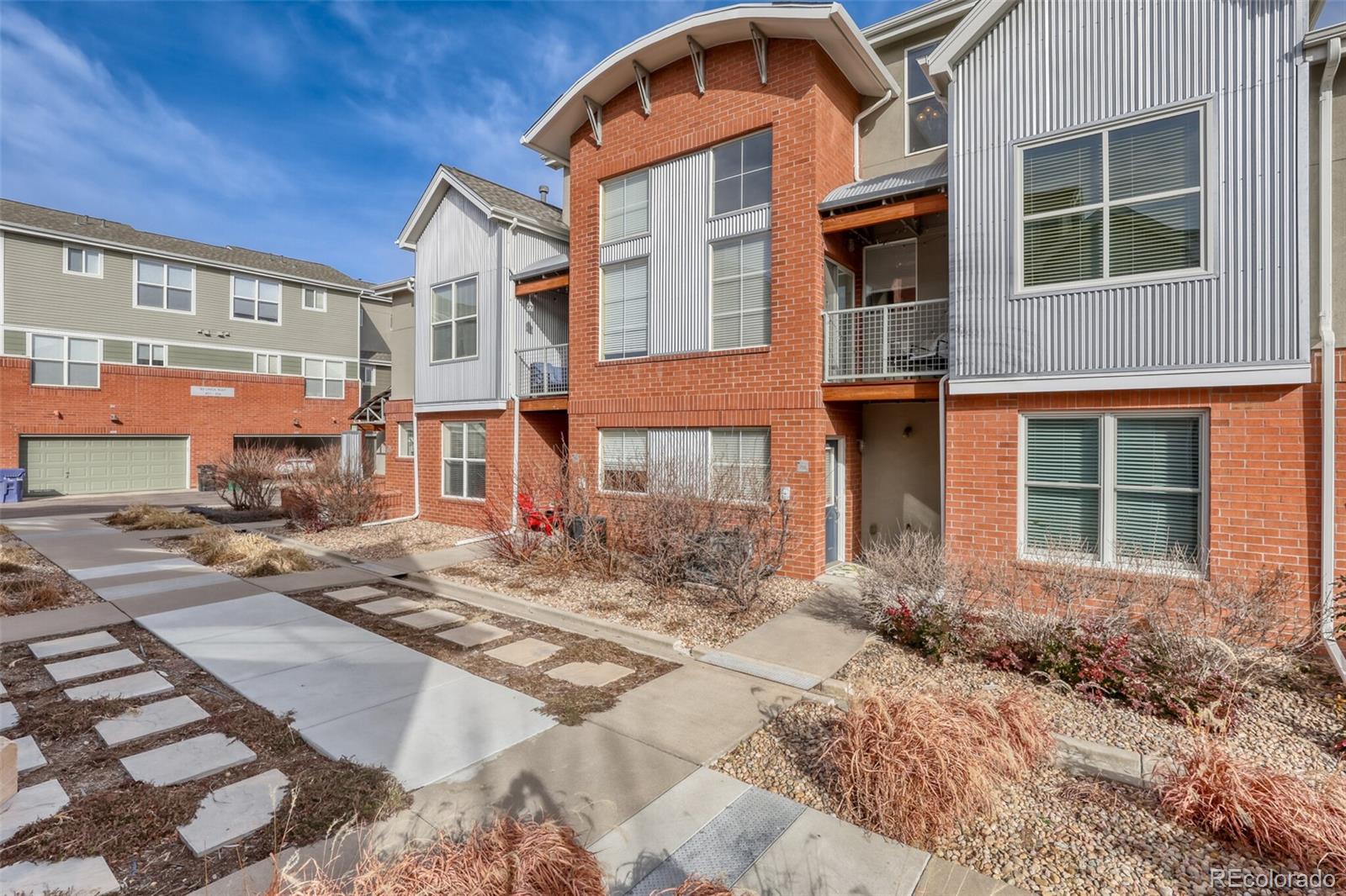 85 Uinta Way, Unit 702 Denver, CO 80230 - Photo 2 of 28 a front view of a house with a yard