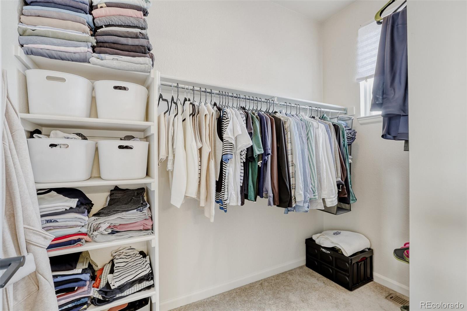 85 Uinta Way, Unit 702 Denver, CO 80230 - Photo 21 of 28 a view of walk in closet with clothes and shoes