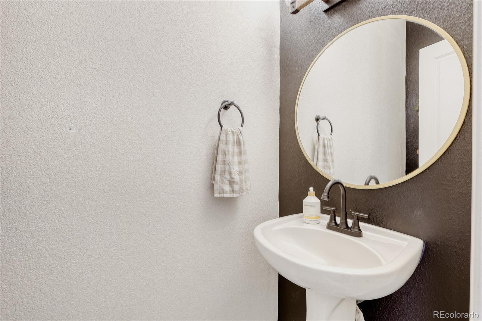 85 Uinta Way, Unit 702 Denver, CO 80230 - Photo 24 of 28 a bathroom with a sink and a mirror