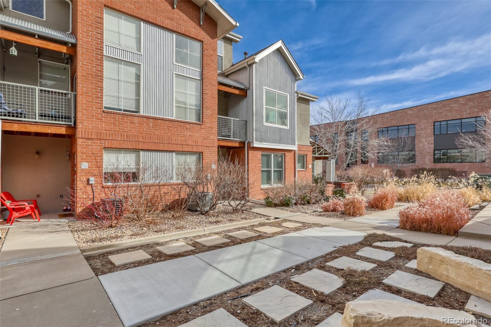 85 Uinta Way, Unit 702 Denver, CO 80230 - Photo 3 of 28 a view of a brick house with many windows