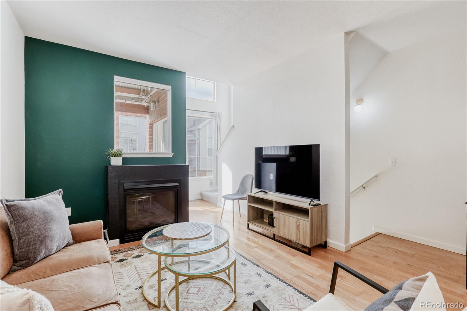 85 Uinta Way, Unit 702 Denver, CO 80230 - Photo 6 of 28 a living room with furniture a fireplace and a flat screen tv