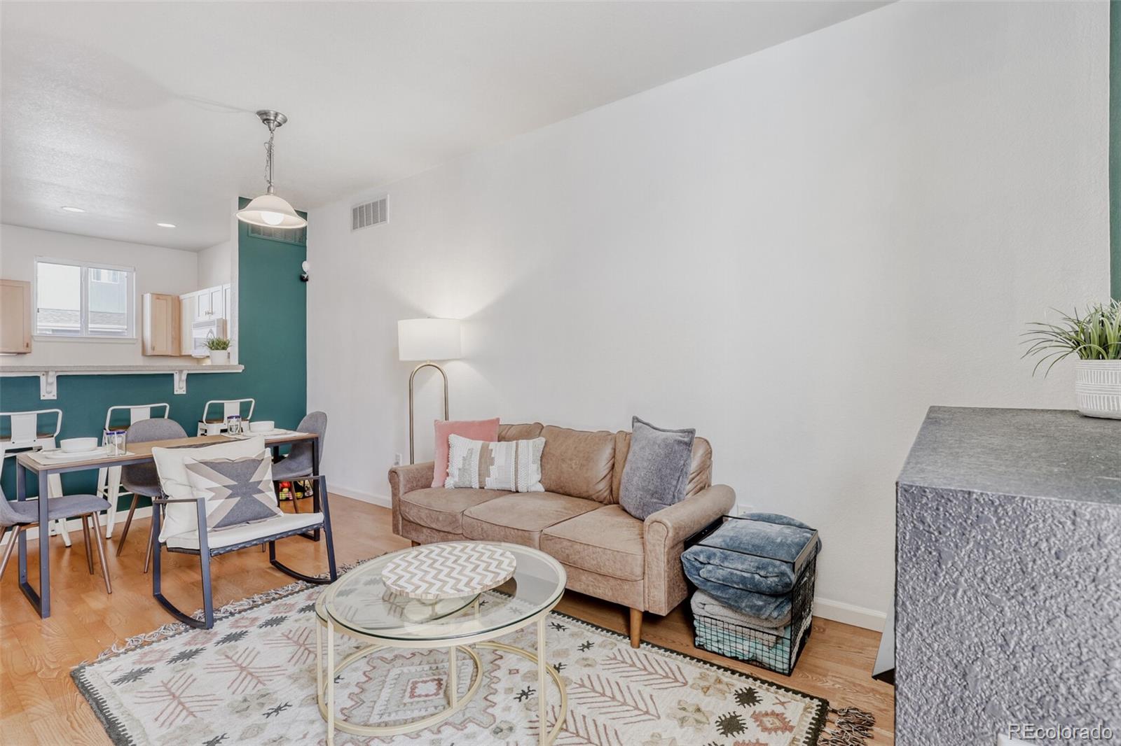 85 Uinta Way, Unit 702 Denver, CO 80230 - Photo 7 of 28 a living room with furniture a table and chair