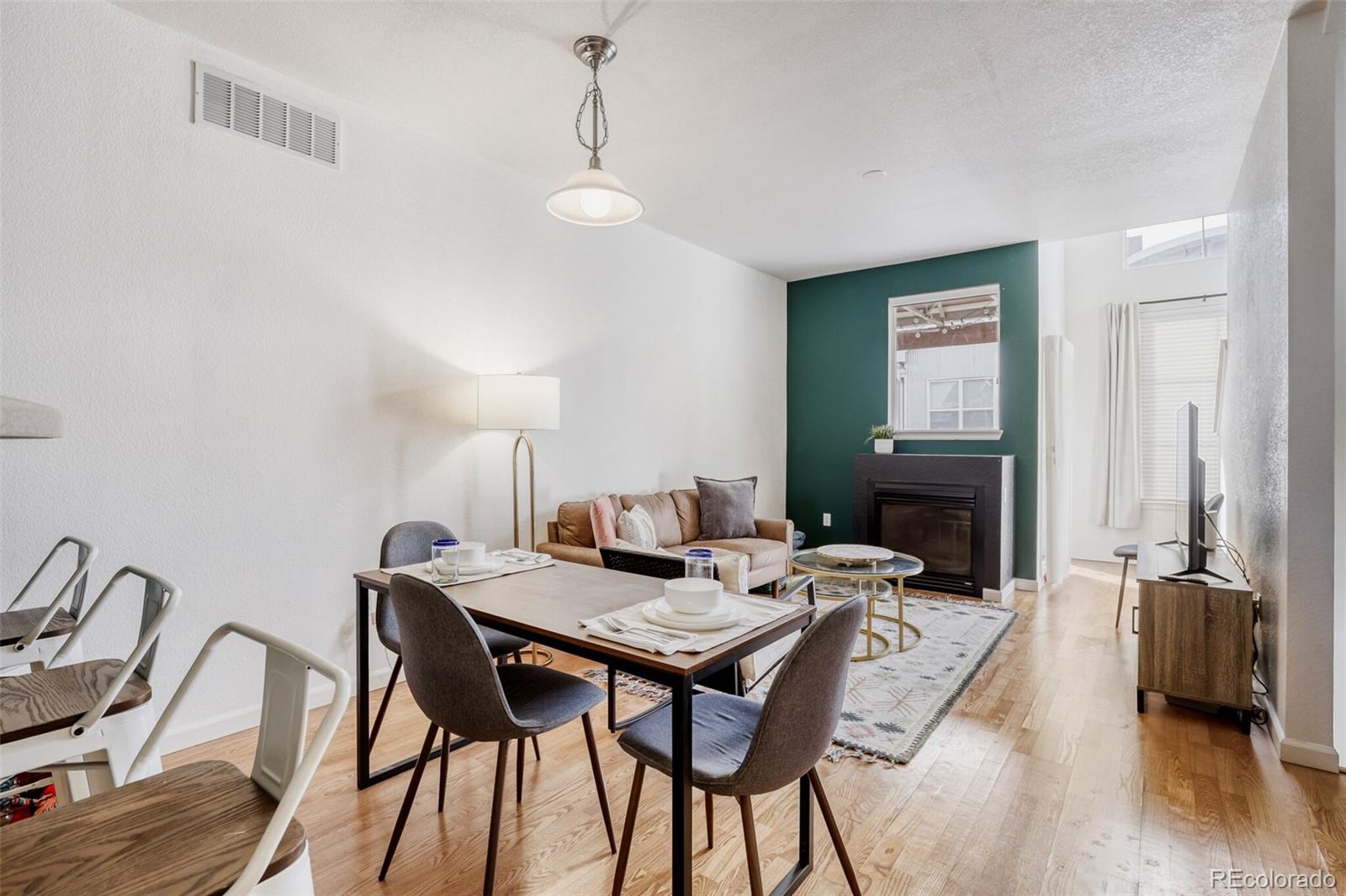 85 Uinta Way, Unit 702 Denver, CO 80230 - Photo 8 of 28 a view of a dining room with furniture and wooden floor