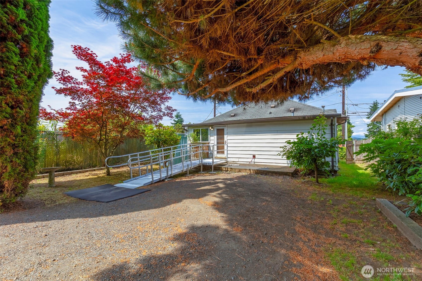 1112 Perry Avenue Bremerton, WA 98310 - Photo 12 of 21 a backyard of a house with table and chairs and potted plants