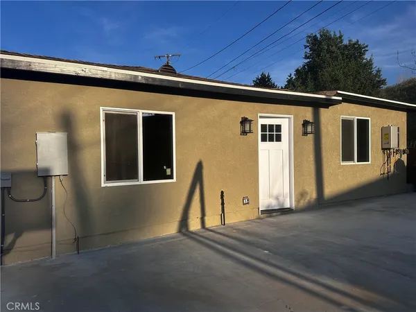a front view of a house with a wooden fence