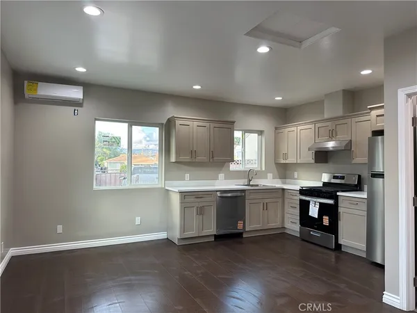 a large kitchen with stainless steel appliances granite countertop a stove and a sink