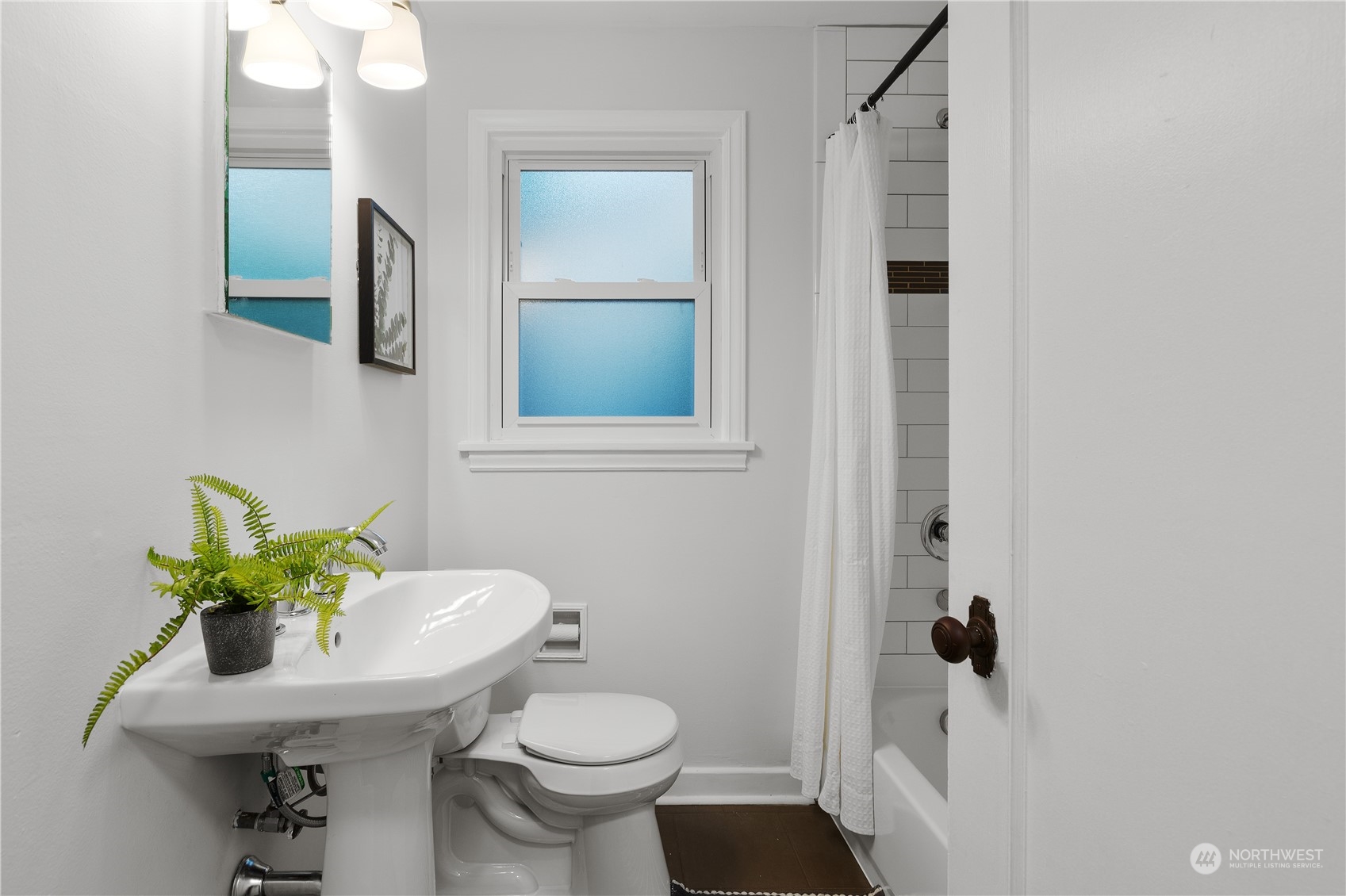 14357 36th Avenue Northeast Seattle, WA 98125 - Photo 13 of 23 a bathroom with a sink toilet and a mirror