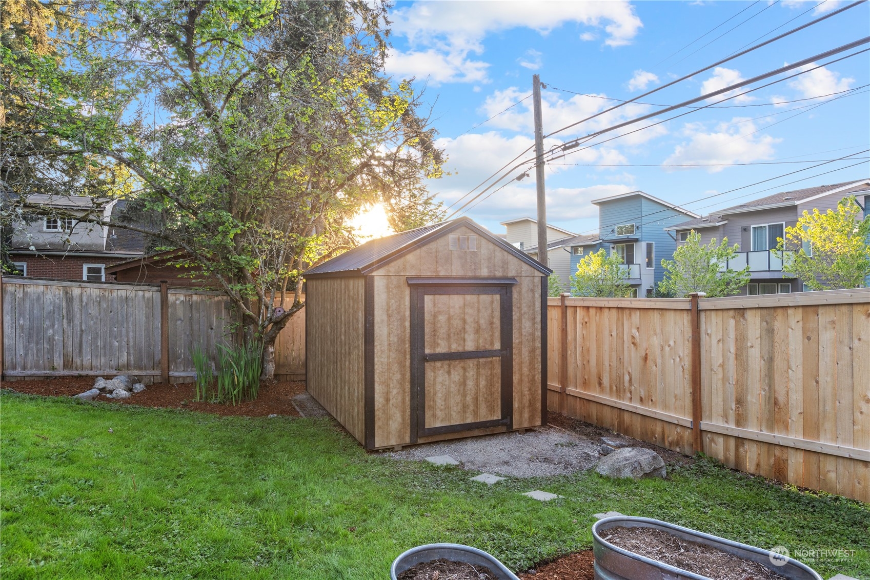 14357 36th Avenue Northeast Seattle, WA 98125 - Photo 23 of 23 a backyard of a house with plants and wooden fence