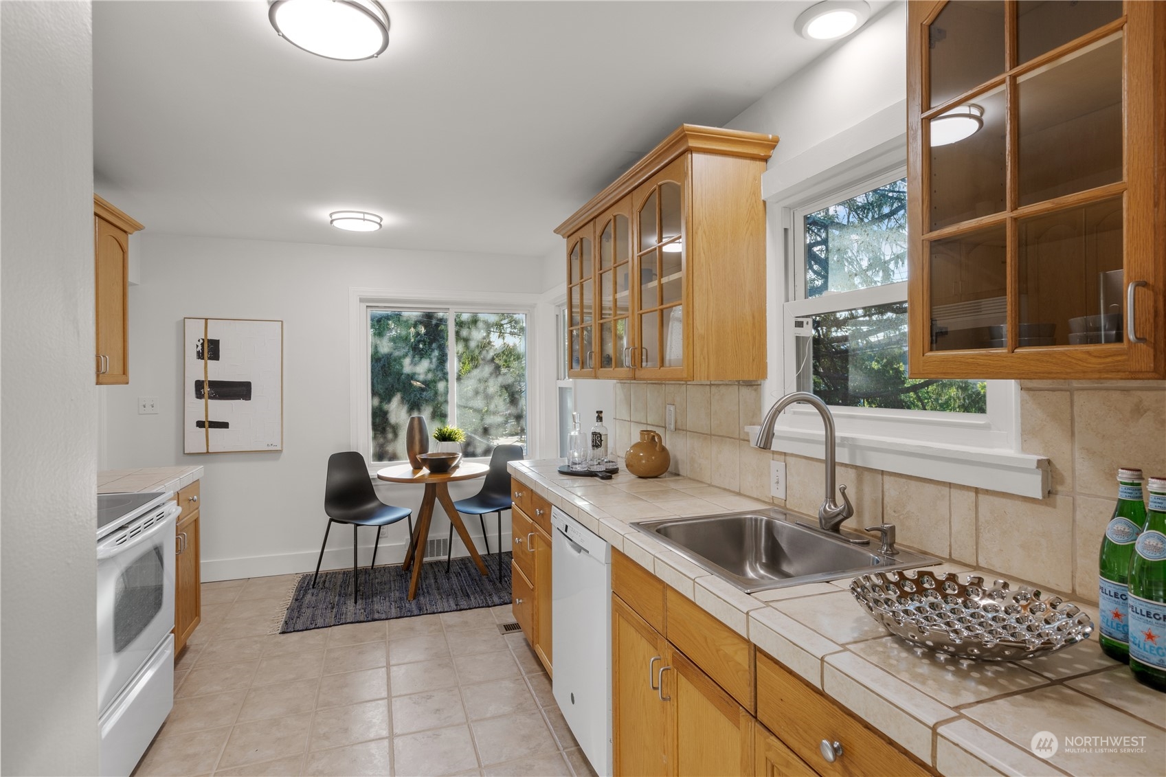 14357 36th Avenue Northeast Seattle, WA 98125 - Photo 6 of 23 a kitchen that has a sink and chairs in it
