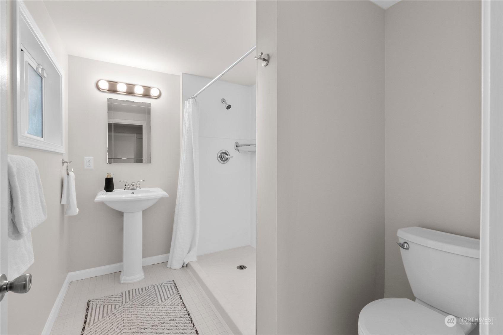 14357 36th Avenue Northeast Seattle, WA 98125 - Photo 10 of 23 a bathroom with a toilet a sink and mirror