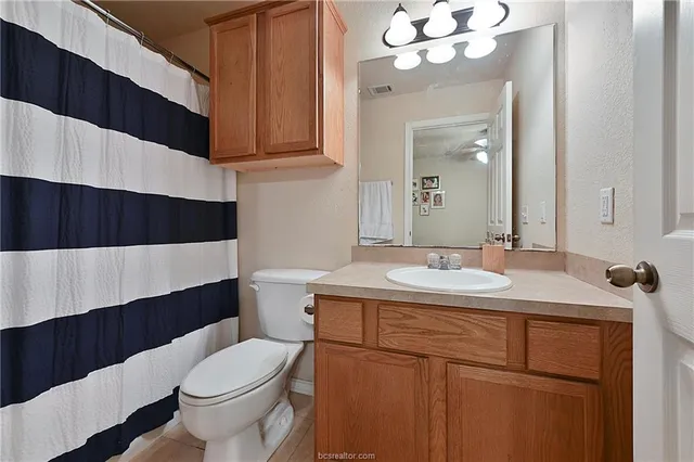 a bedroom with bed and a chandelier