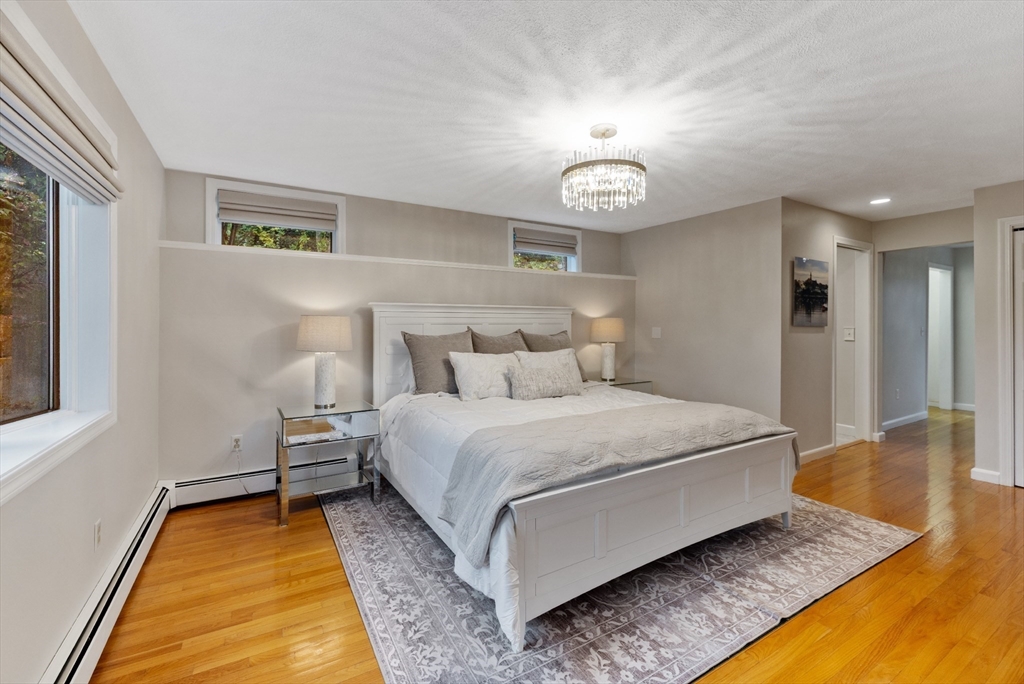 25 Curtis Street Marblehead, MA 01945 - Photo 12 of 28 a spacious bedroom with a bed and a table in it