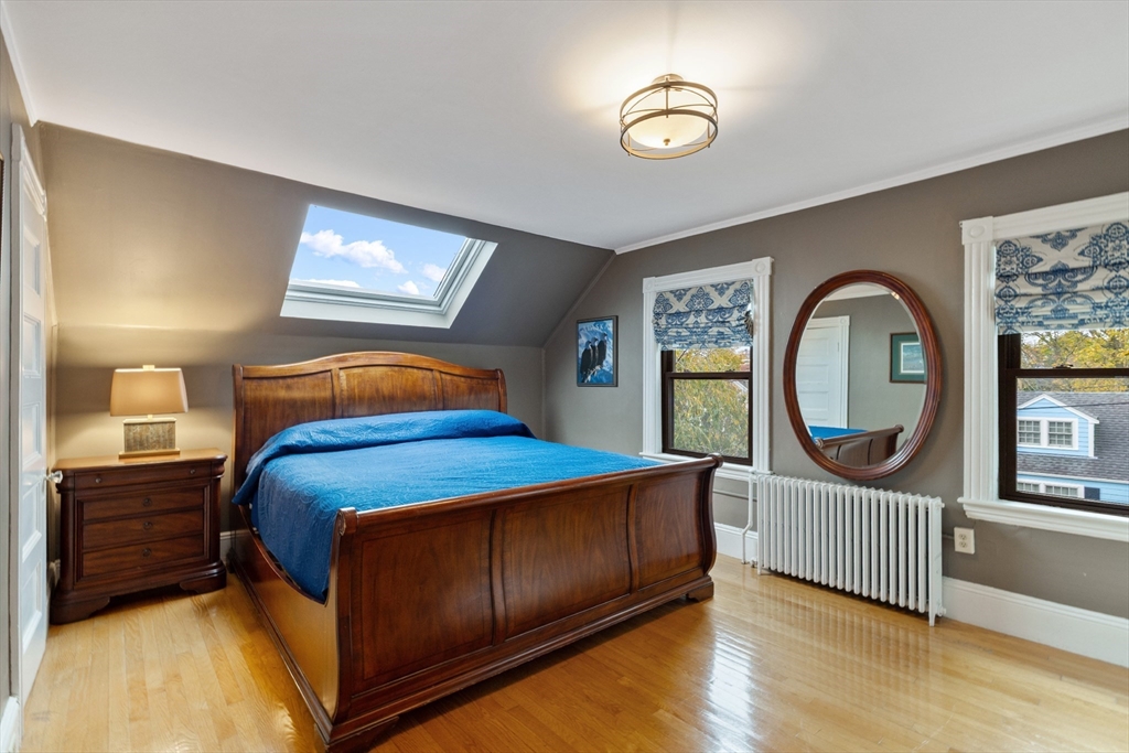 25 Curtis Street Marblehead, MA 01945 - Photo 16 of 28 a bedroom with a bed a mirror and a window