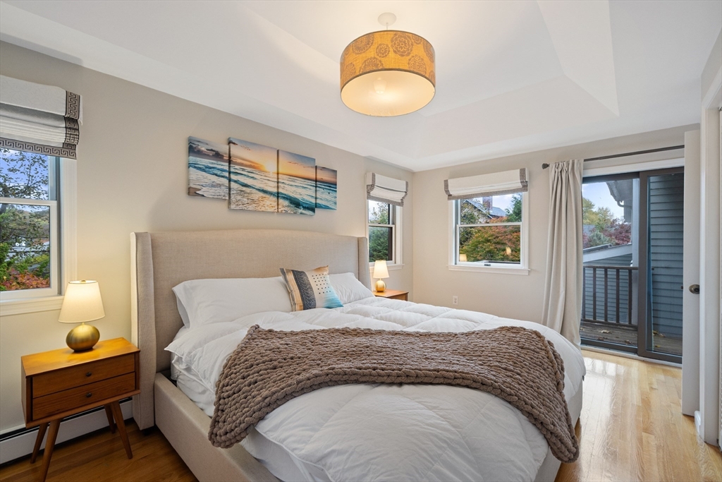25 Curtis Street Marblehead, MA 01945 - Photo 20 of 28 a bedroom with a bed and wooden floor