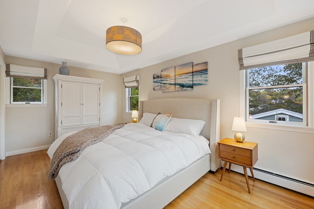 25 Curtis Street Marblehead, MA 01945 - Photo 21 of 28 a bedroom with a bed and a painting on the wall