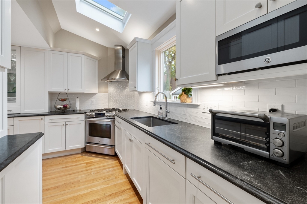 25 Curtis Street Marblehead, MA 01945 - Photo 5 of 28 a kitchen with stainless steel appliances granite countertop a sink and stove top oven