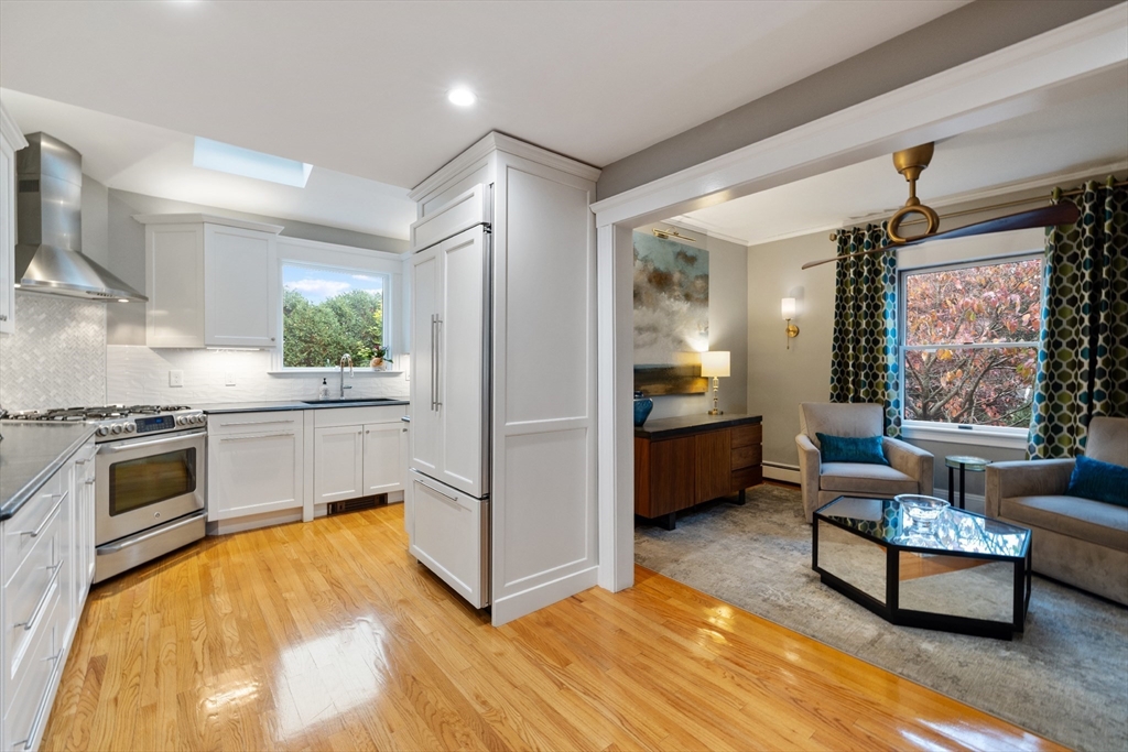 25 Curtis Street Marblehead, MA 01945 - Photo 6 of 28 a kitchen with kitchen island a counter top space a sink stainless steel appliances and cabinets