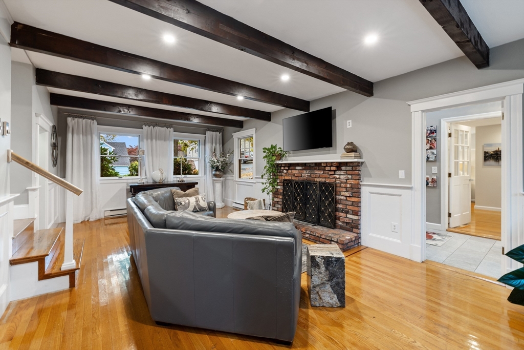 25 Curtis Street Marblehead, MA 01945 - Photo 10 of 28 a living room with fireplace furniture and a wooden floor
