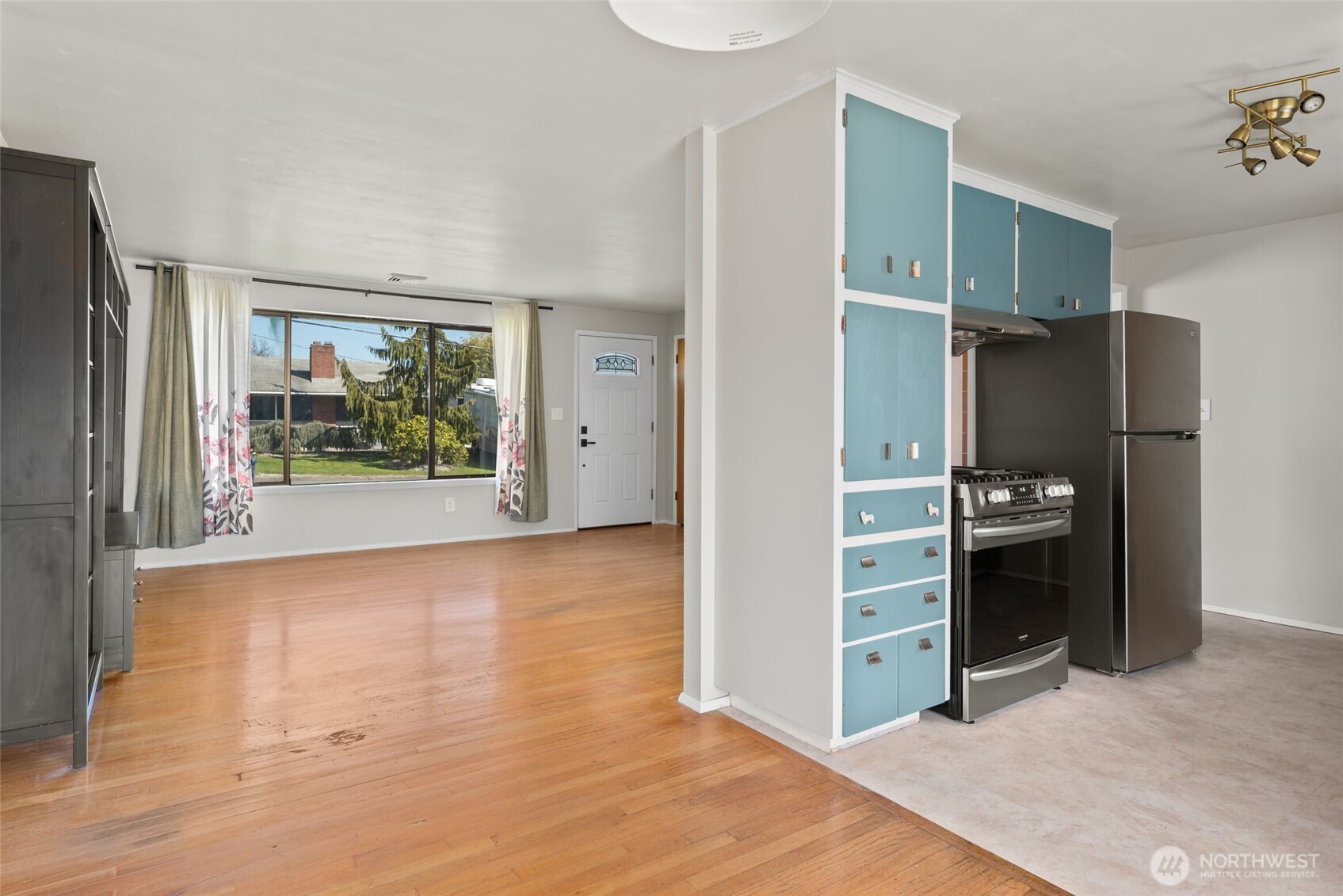 1805 37th Street Anacortes, WA 98221 - Photo 12 of 40 a view of a kitchen with refrigerator and an empty room