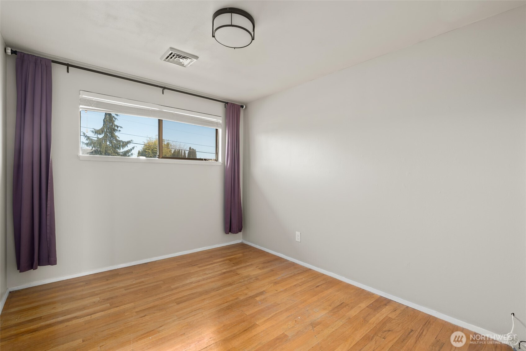 1805 37th Street Anacortes, WA 98221 - Photo 18 of 40 a view of a room with wooden floor and window
