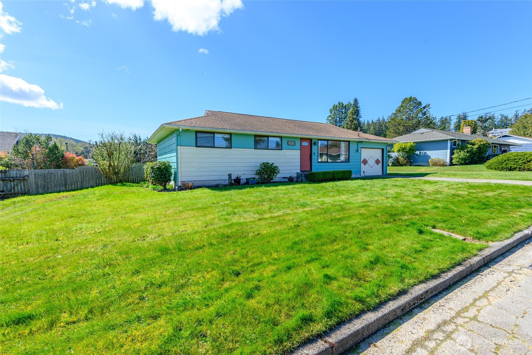 1805 37th Street Anacortes, WA 98221 - Photo 2 of 40 a view of a house with a big yard and large trees