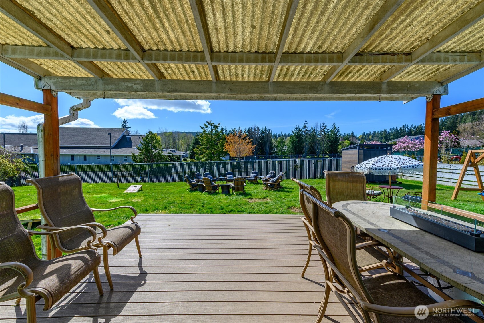 1805 37th Street Anacortes, WA 98221 - Photo 33 of 40 a view of a chairs and table in patio with a yard
