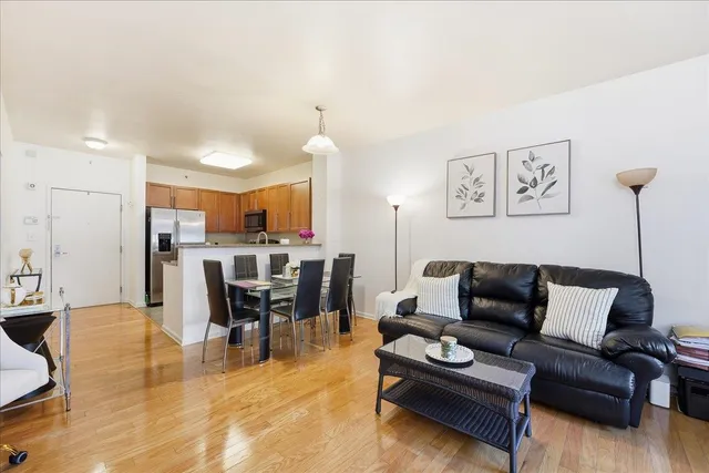 a living room with furniture and a dining table with kitchen view