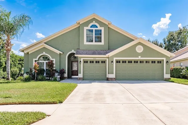 a front view of a house with a yard and garage