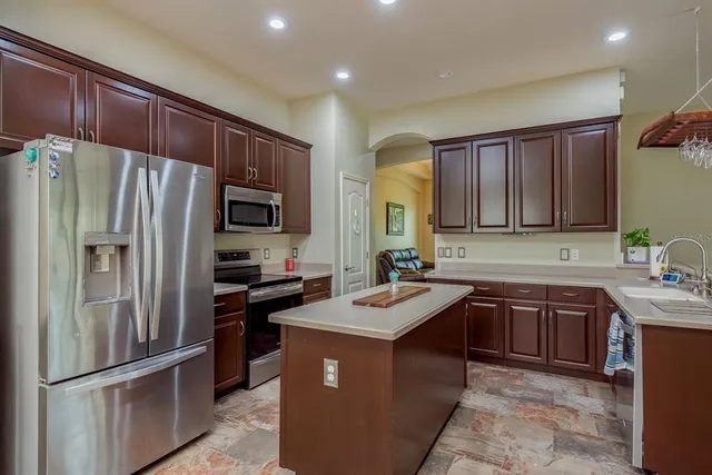 a spacious bedroom with a bed and a chandelier
