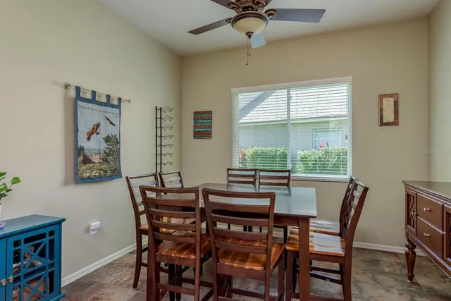 a view of a house with a yard and potted plants
