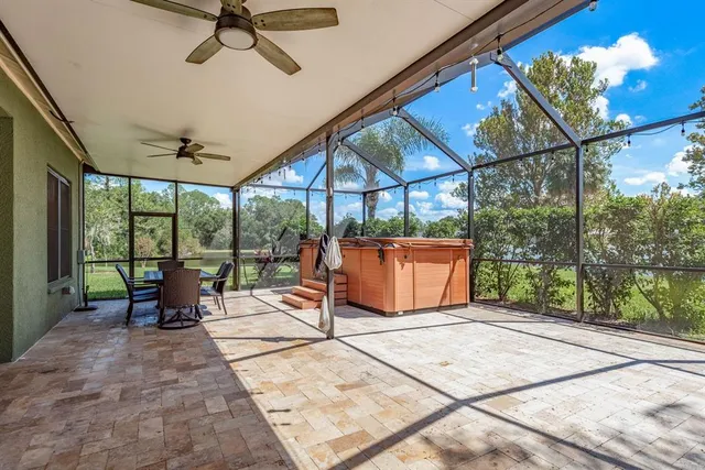 a living room with furniture a flat screen tv and a chandelier