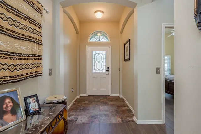 a living room with furniture and kitchen view
