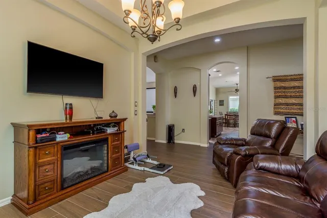 a bedroom with a bed and a chandelier