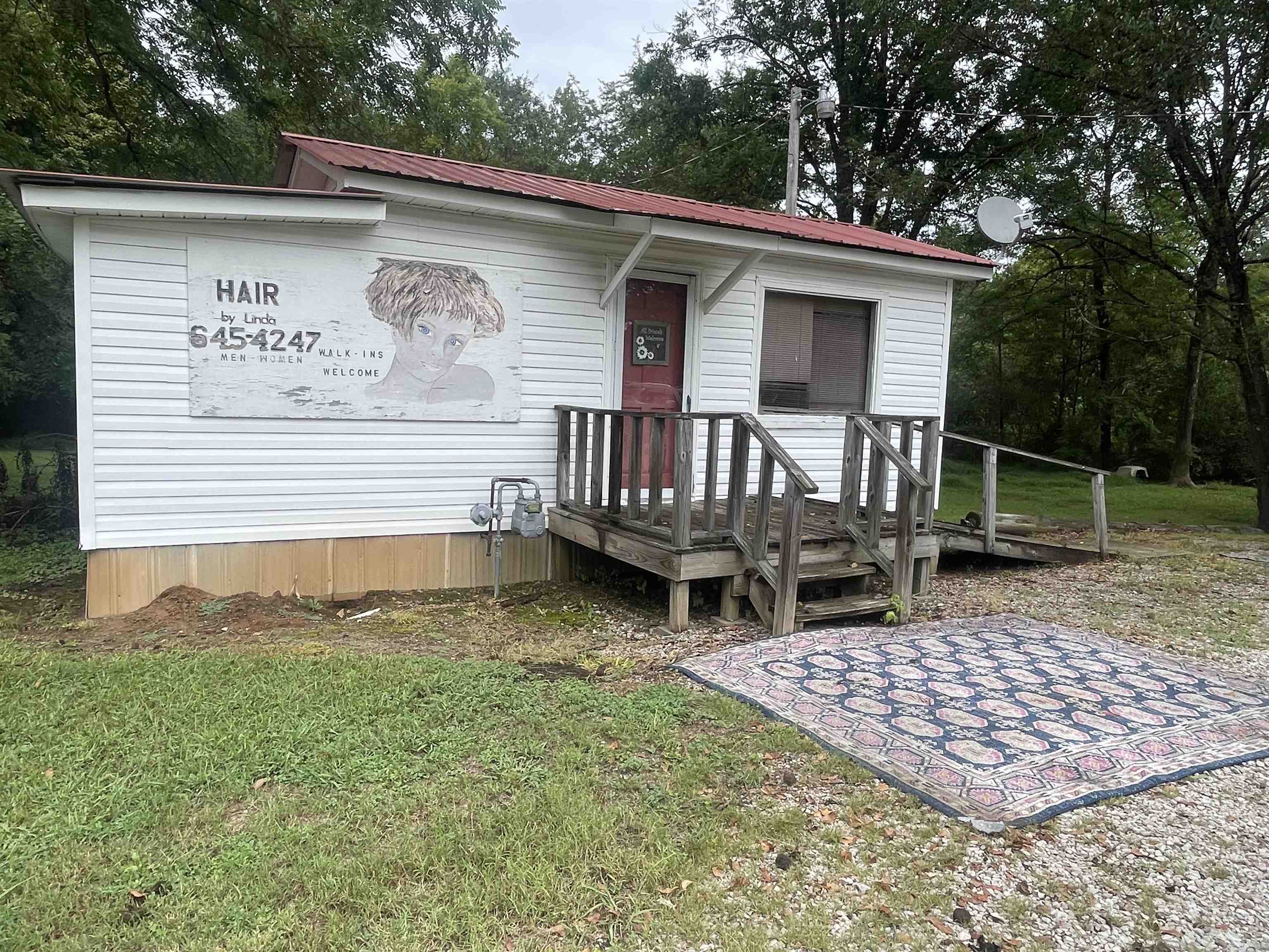 213 Adams Selmer, TN 38375 - Photo 1 of 16 a view of a wooden deck with a bench