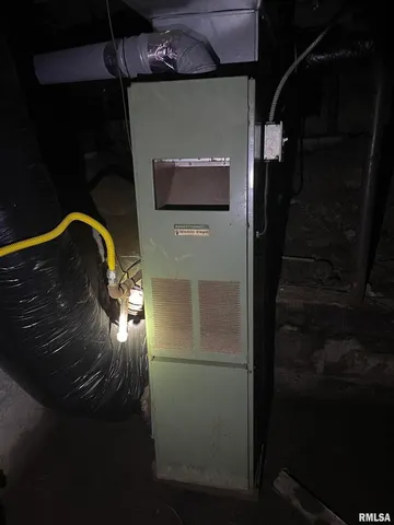 a room with water heater and wooden floor