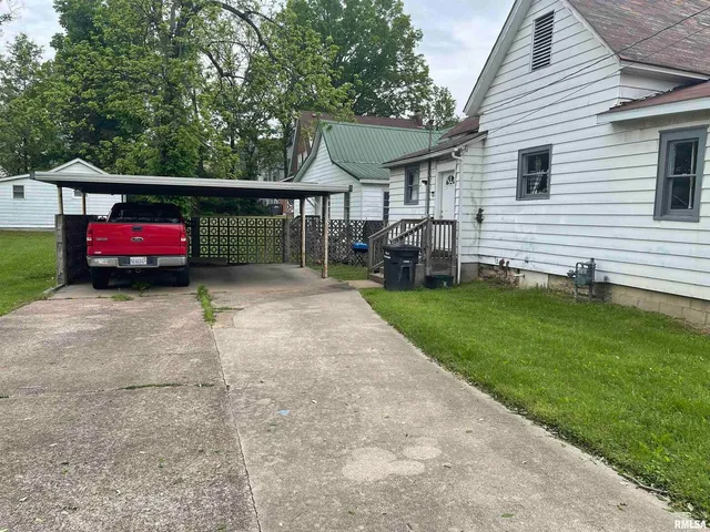a view of a house with a yard and sitting area