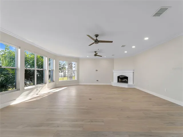 a view of a livingroom with wooden floor and windows
