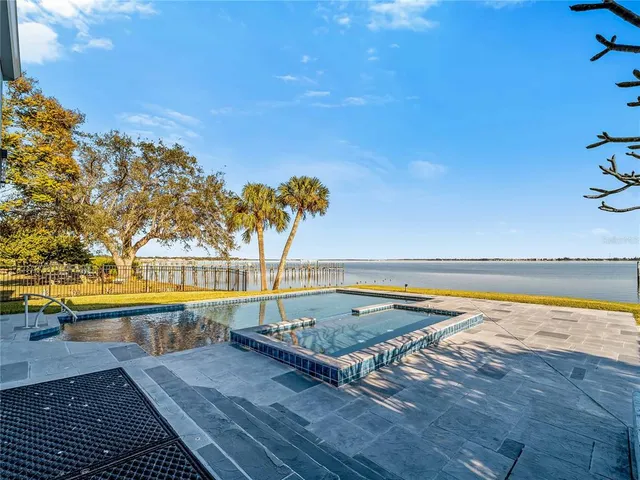 a spacious bathroom with a granite countertop sink a toilet and mirror