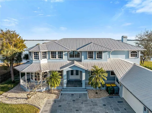 a view of a room with wooden floor windows and a chandelier