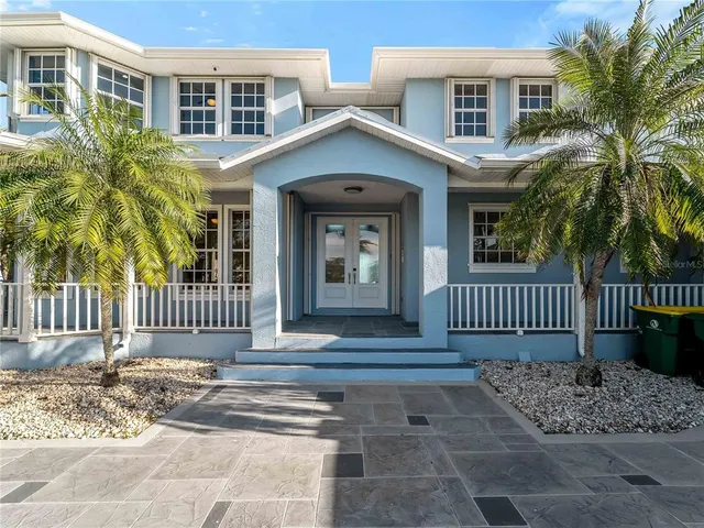 a kitchen with stainless steel appliances granite countertop a sink a refrigerator and a granite counter tops