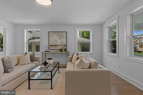 a living room with furniture and a clock