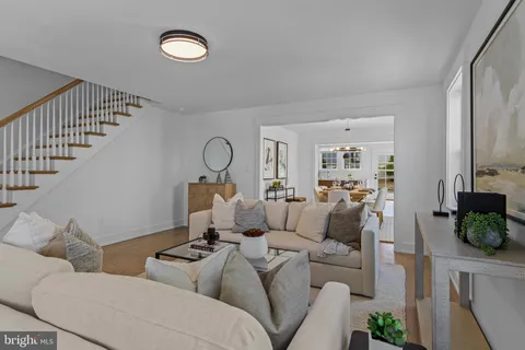 a view of a dining room with furniture a chandelier and wooden floor