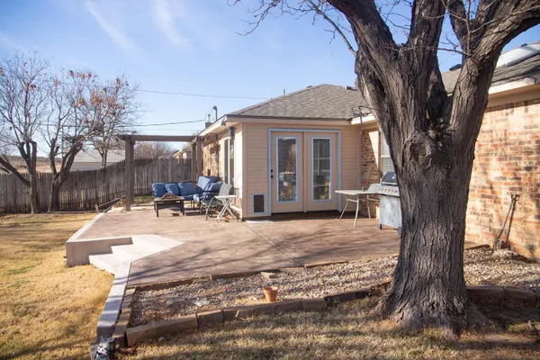 a view of a dinning tables and chairs in backyard of the house