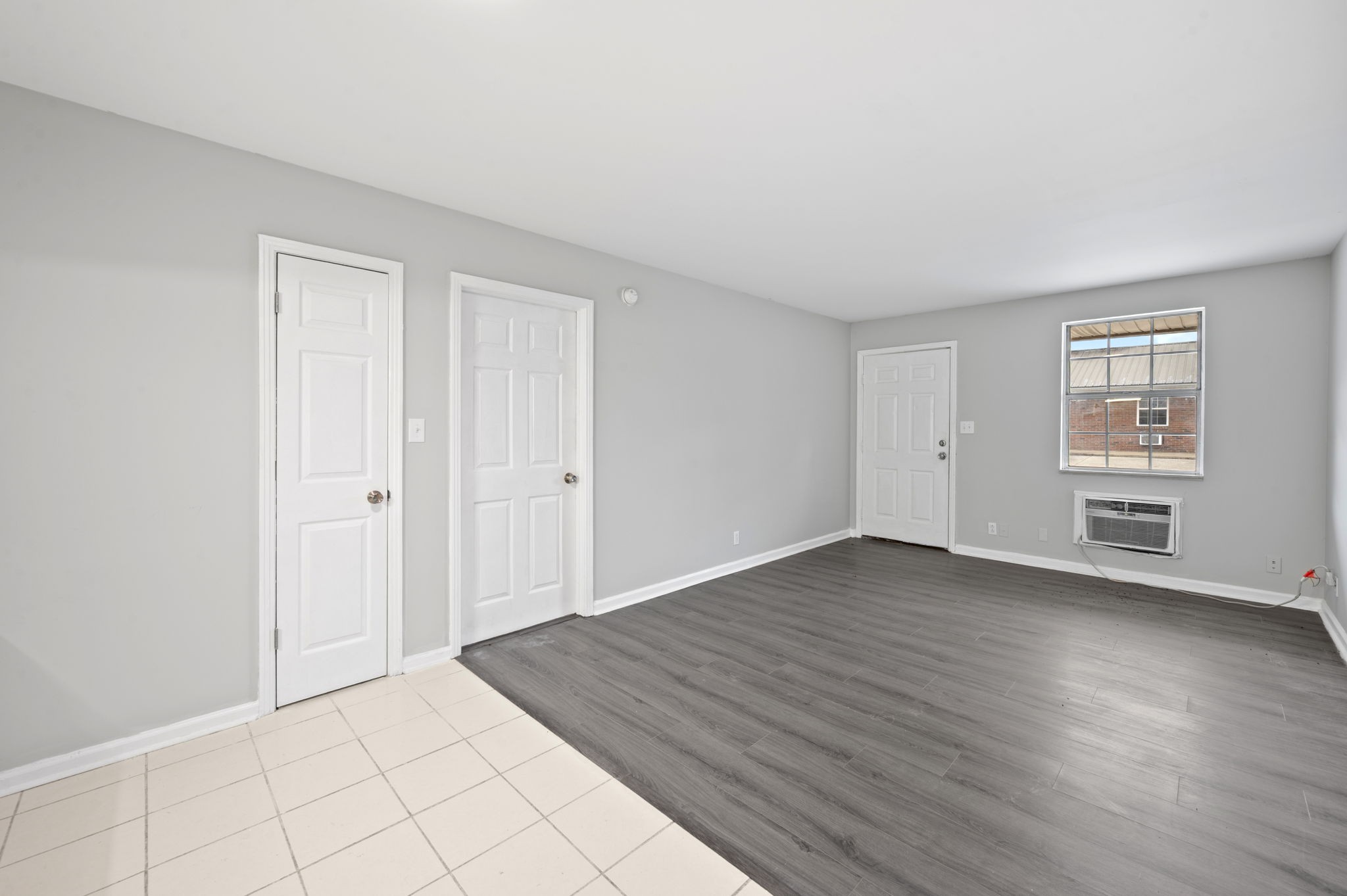 101 Walnut Street, Unit 19 Clarksville, TN 37042 - Photo 6 of 12 a view of an empty room with wooden floor and a window